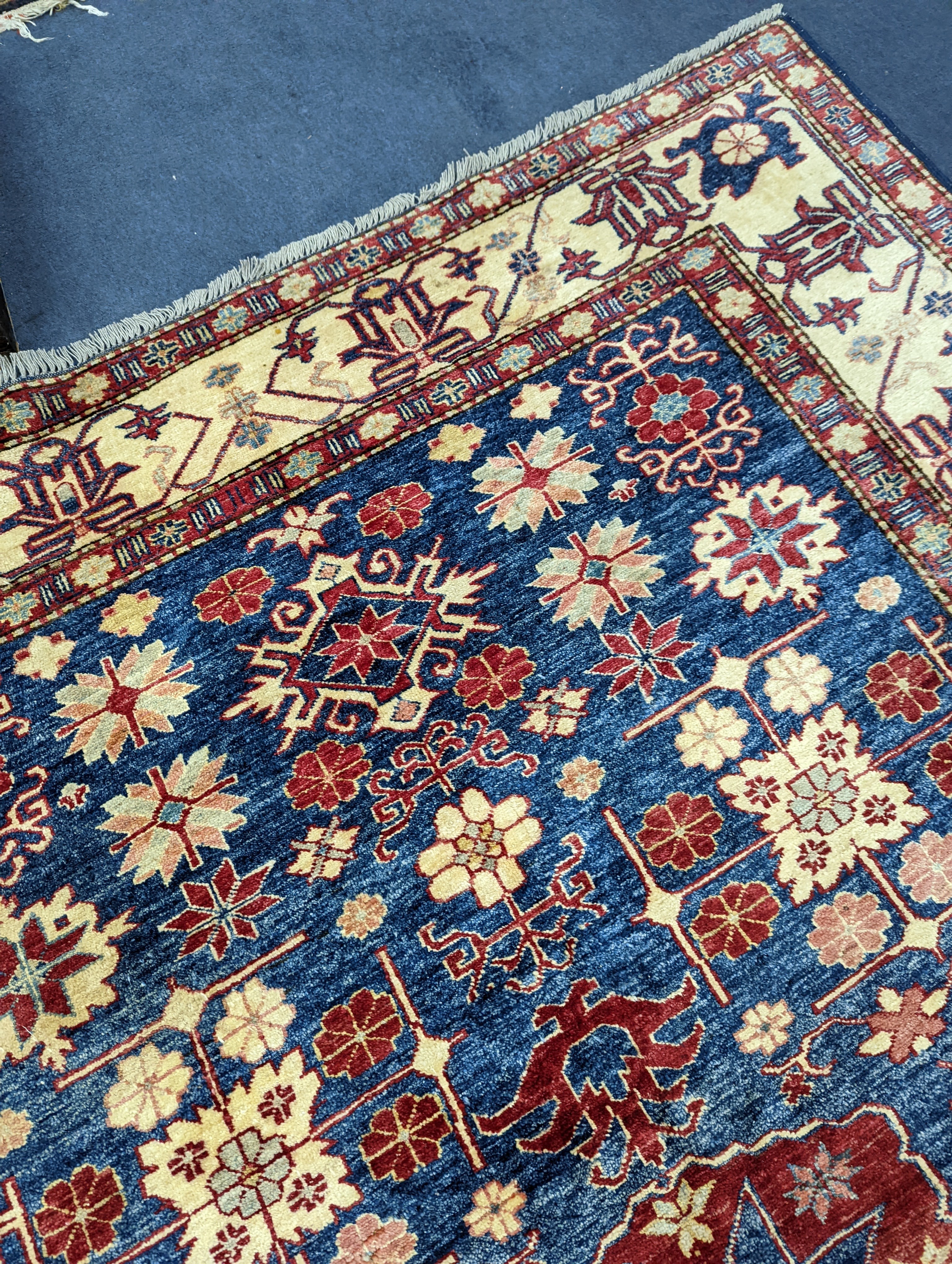 A Kazak blue ground carpet, 242 x 186cm